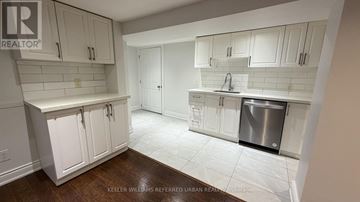 Toronto (Yorkdale-Glen Park) apartment for rent - A kitchen with white cabinets and a stainless steel dishwasher.