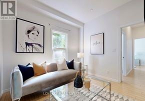 Brampton (Downtown Brampton) apartment for rent - A living room with a white couch and a glass coffee table.