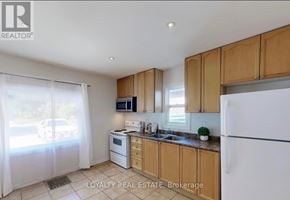Brampton (Downtown Brampton) apartment for rent - A kitchen with wooden cabinets and a white refrigerator.