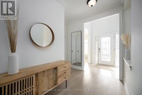 Lincoln (Lincoln-Jordan/Vineland) apartment for rent - A white hallway with a wooden bench and a round mirror on the wall.