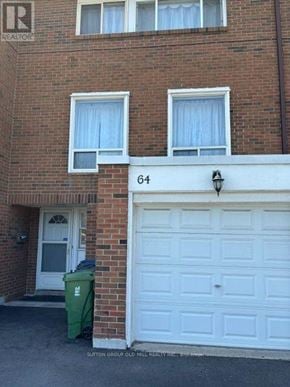 Toronto (Mount Olive-Silverstone-Jamestown) townhouse for rent - A brick building with the number 64 on the front.