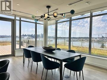 North Vancouver apartment for rent - A dining room with a table and chairs with a view of the water.