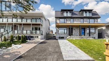 Toronto (Yorkdale-Glen Park) townhouse for rent - A modern two-story house with a driveway in front.