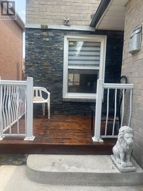 Brampton (Northwood Park) apartment for rent - A white chair is on a wooden deck next to a lion statue.