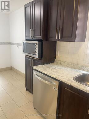 Brampton (Northwood Park) apartment for rent - A kitchen with a stainless steel dishwasher and microwave.
