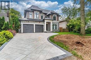 Mississauga (Lakeview) apartment for rent - A large house with a grey garage door is for sale.