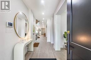 Mississauga (Lakeview) apartment for rent - A hallway with a mirror and a sign that says "REALTOR".