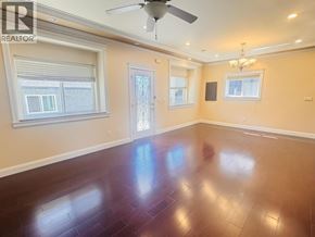 Vancouver apartment for rent - A room with a ceiling fan and wooden flooring.