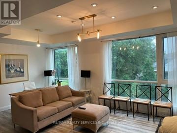 Toronto (Englemount-Lawrence) townhouse for rent - A living room with a couch, a table, and a painting on the wall.