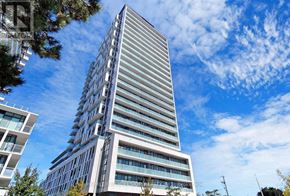 Toronto (Don Valley Village) condo for rent - A tall, modern building with a curved facade stands under a blue sky with clouds.