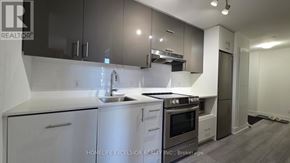 Toronto (Don Valley Village) condo for rent - A modern kitchen with white cabinets and stainless steel appliances.