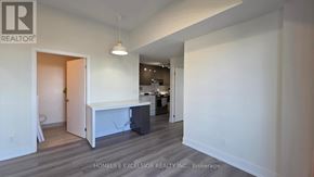 Toronto (Don Valley Village) condo for rent - A realtor logo is on a wall in a white room.