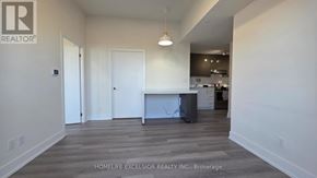 Toronto (Don Valley Village) condo for rent - A spacious living room with a kitchen in the background.