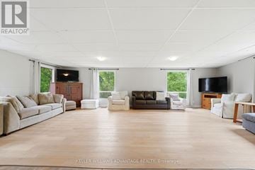 Halton Hills (Rural Halton Hills) apartment for rent - A spacious living room with a large couch and a television.