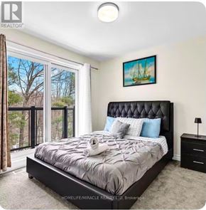 Brampton (Credit Valley) townhouse for rent - A bedroom with a large bed and a painting on the wall.