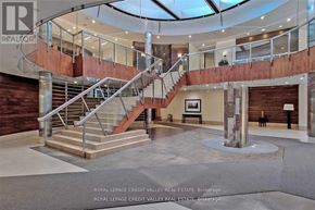 Mississauga (City Centre) condo for rent - A large atrium with a staircase and a skylight.