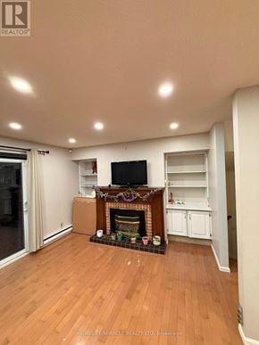 Kingston (Central City East) townhouse for rent - A living room with a fireplace and a flat screen TV.