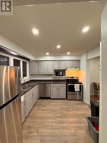 Kingston (Central City East) townhouse for rent - A kitchen with a refrigerator, sink, and cabinets.