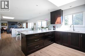 Delta apartment for rent - A modern kitchen with dark wood cabinets and a white island.