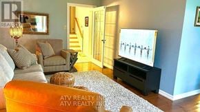 Pickering (Bay Ridges) apartment for rent - A living room with a television, a couch, a chair, and a rug.