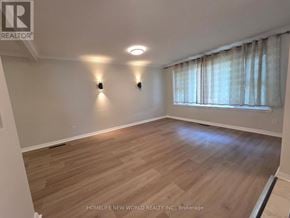Whitby (Downtown Whitby) apartment for rent - A room with wooden flooring and two wall lights.