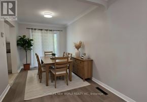 Whitby (Downtown Whitby) apartment for rent - A dining room with a table set for six with a white tablecloth and a plant in a red pot.
