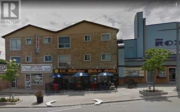 Uxbridge house for rent - A street view of a building with a sign that reads "Col. Atterbough Pub & Grill".