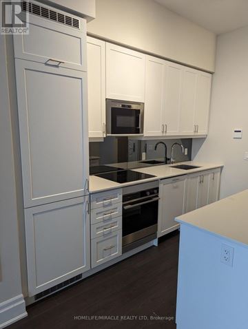 Vaughan (Concord) condo for rent - A kitchen with white cabinets and a stainless steel oven.