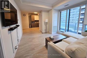 Markham (Unionville) condo for rent - A living room with a white couch and a wooden coffee table.