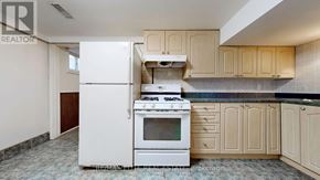 Richmond Hill (Harding) apartment for rent - A white stove and oven in a kitchen with wooden cabinets.