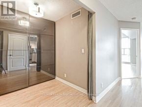 Mississauga (City Centre) condo for rent - A room with a sliding door and a mirror on the wall.