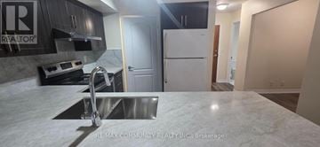 Mississauga (City Centre) condo for rent - A kitchen with a white counter top and a stainless steel sink.
