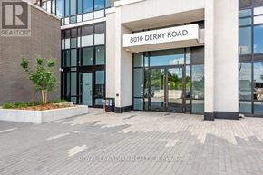 Milton (Co Coates) condo for rent - The front of a building with the sign 8010 Derry Road on it.
