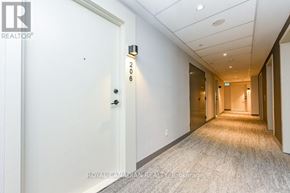 Milton (Co Coates) condo for rent - A hallway with a door on the left and a light on the wall on the right.