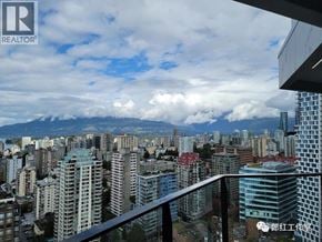 Vancouver apartment for rent - A cityscape with a mountain range in the background.
