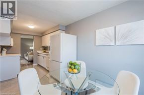 Kitchener townhouse for rent - A modern kitchen with a glass table and white chairs.