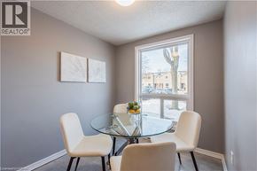 Kitchener townhouse for rent - A dining room with a glass table and four chairs.