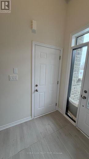 Kawartha Lakes (Lindsay) townhouse for rent - A white door is in a room with a light switch on the wall.