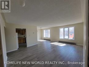 Cramahe (Colborne) apartment for rent - A spacious room with wooden flooring and a large window.