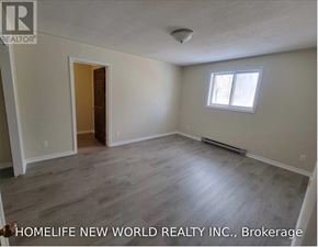 Cramahe (Colborne) apartment for rent - A room with a door and a window, with the text "HOMELIFE NEW WORLD REALTY INC., Brokerage" on the bottom.