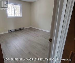 Cramahe (Colborne) apartment for rent - A room with a window and a wooden floor.