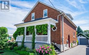 Oshawa (Lakeview) apartment for rent - A house with a porch covered in green vines.