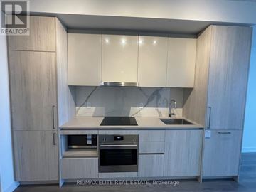 Vaughan (Vaughan Corporate Centre) condo for rent - A modern kitchen with wooden cabinets and stainless steel appliances.