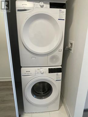 Vaughan (Vaughan Corporate Centre) condo for rent - A white front loading washing machine and dryer by Gorene.