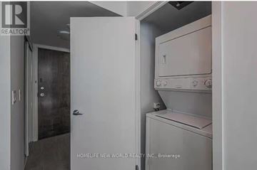 Toronto (Waterfront Communities) condo for rent - A white door is open to reveal a white dishwasher and dryer in a kitchen.