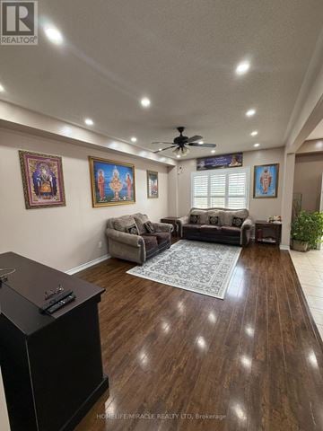 Brampton (Bram East) apartment for rent - A living room with a ceiling fan and a rug on the floor.