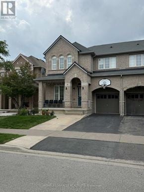 Brampton (Bram East) apartment for rent - A large brick house with a basketball hoop on the front.
