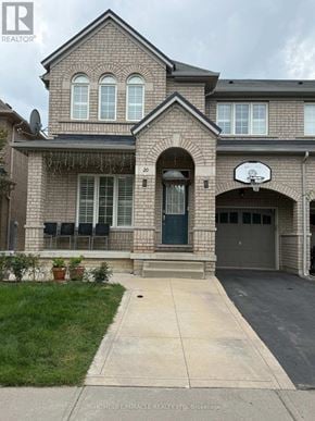 Brampton (Bram East) apartment for rent - A brick house with a basketball hoop on the front.