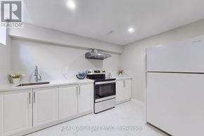 Whitby (Rolling Acres) apartment for rent - A white kitchen with a refrigerator, oven, and sink.