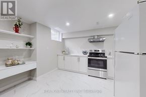 Whitby (Rolling Acres) apartment for rent - A white kitchen with a refrigerator, oven, and shelves.